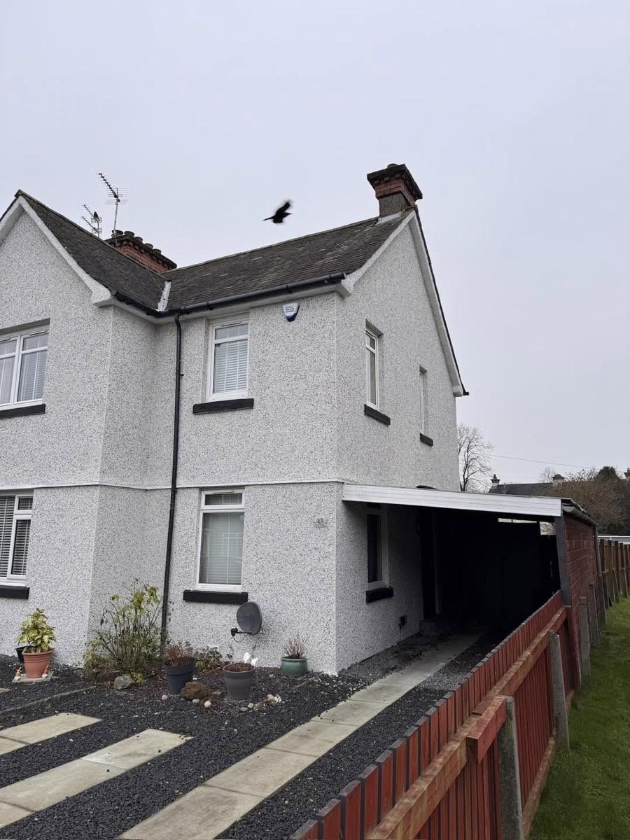 Painted brick and old roughcast taken to white and black dash, finished