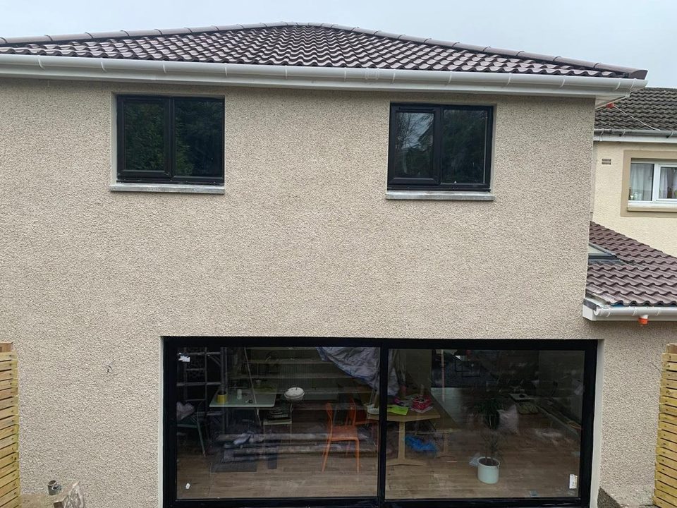 Two storey extension: blockwork, scratch coat, finished roughcast