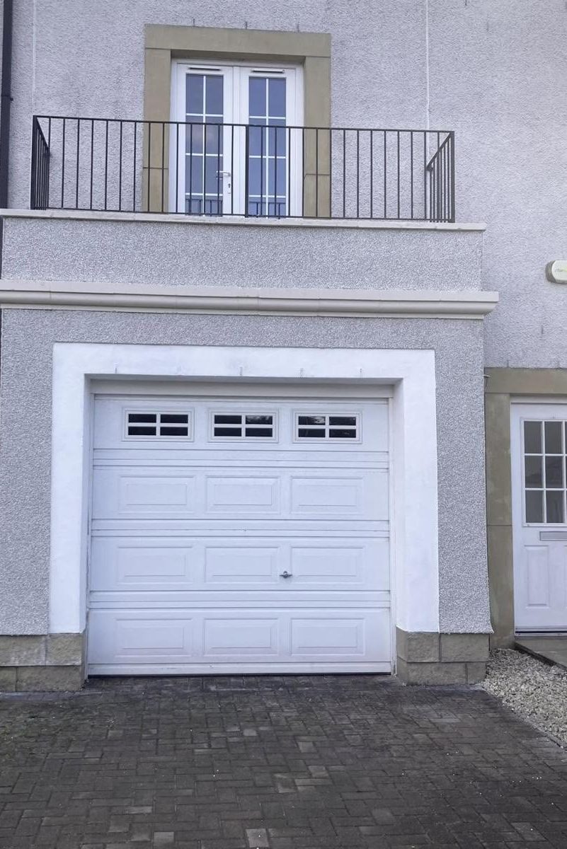 Failed render round a garage and balcony put right