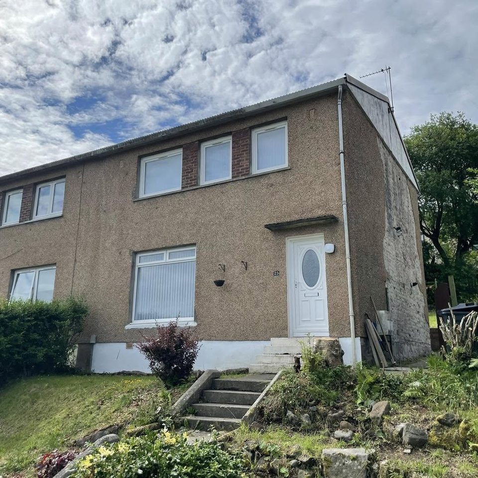 Pebble dash and bare stone to smooth cream render, before we started